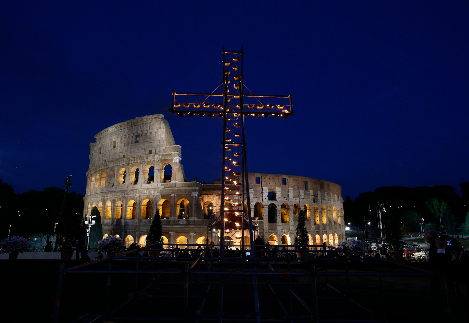 An illuminated cross is seen April 19, 2019, outside Rome's Colosseum before Pope Francis leads the Way of the Cross.